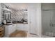 Bathroom featuring dual sinks, walk-in shower and floral accent wall at 1575 Lewis Farm Rd, Kings Mountain, NC 28086