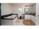 Bright bathroom features a soaking tub and floral wallpaper at 1575 Lewis Farm Rd, Kings Mountain, NC 28086