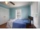 This bedroom features a large window with natural light and blue walls at 1575 Lewis Farm Rd, Kings Mountain, NC 28086