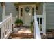 Inviting front entry features a white door, seasonal wreath, and decorative potted plants at 1575 Lewis Farm Rd, Kings Mountain, NC 28086
