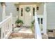 Inviting front porch with plants and a decorative wreath on the front door at 1575 Lewis Farm Rd, Kings Mountain, NC 28086