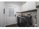 Convenient laundry room with modern washer, dryer, cabinets and access to the backyard at 1575 Lewis Farm Rd, Kings Mountain, NC 28086