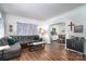 Cozy living room featuring hardwood floors, a gray sofa, and an open view into the dining area at 1575 Lewis Farm Rd, Kings Mountain, NC 28086