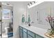 Bright bathroom featuring a blue vanity, a large mirror, and modern fixtures at 176 Pleasant Grove Ln, Mooresville, NC 28115