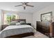 Cozy bedroom with a ceiling fan, carpet, and a large window overlooking the outdoors at 176 Pleasant Grove Ln, Mooresville, NC 28115