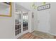 Bright foyer with hardwood floors leads to an office with glass french doors at 176 Pleasant Grove Ln, Mooresville, NC 28115