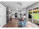 Open-concept kitchen with stainless steel appliances, white cabinetry, a dining table, and backyard access at 176 Pleasant Grove Ln, Mooresville, NC 28115