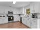 Modern kitchen with white cabinetry, stainless steel appliances, and subway tile backsplash at 176 Pleasant Grove Ln, Mooresville, NC 28115