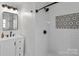Modern shower with white subway tile, dark fixtures, and a decorative mosaic accent at 176 Pleasant Grove Ln, Mooresville, NC 28115