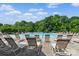 A community swimming pool with lounge chairs and a surrounding tree line at 176 Pleasant Grove Ln, Mooresville, NC 28115
