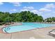 A community swimming pool with lounge chairs and a surrounding tree line at 176 Pleasant Grove Ln, Mooresville, NC 28115