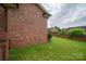 Brick home featuring a manicured lawn and partial brick fencing, offering privacy and curb appeal at 1909 Wexford Ct, Gastonia, NC 28054