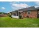 Picture of a brick house with a screened-in porch and well-kept lawn at 1909 Wexford Ct, Gastonia, NC 28054