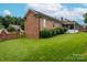 Brick home featuring an enclosed porch, brick fence and lush lawn at 1909 Wexford Ct, Gastonia, NC 28054
