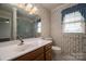 Bathroom featuring wooden vanity, and a shower with glass doors at 1909 Wexford Ct, Gastonia, NC 28054
