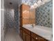 Bathroom featuring floral wallpaper, wooden vanity, and tile flooring at 1909 Wexford Ct, Gastonia, NC 28054