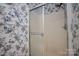 Bathroom featuring floral wallpaper and a shower with glass doors at 1909 Wexford Ct, Gastonia, NC 28054