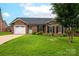 Beautiful brick home boasts a manicured lawn and attached two-car garage at 1909 Wexford Ct, Gastonia, NC 28054