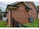 Brick home exterior featuring an air conditioning unit and a black iron fence at 1909 Wexford Ct, Gastonia, NC 28054