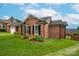 Charming brick home featuring a landscaped yard and classic black shutters at 1909 Wexford Ct, Gastonia, NC 28054