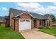 Exterior of brick home boasts a manicured lawn, driveway, and attached two-car garage at 1909 Wexford Ct, Gastonia, NC 28054