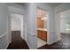Hallway with hardwood floors leading to a bright bedroom and bathroom at 1909 Wexford Ct, Gastonia, NC 28054