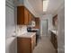 Galley kitchen featuring wood cabinets, white countertops, and white appliances at 1909 Wexford Ct, Gastonia, NC 28054