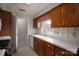Galley kitchen featuring wood cabinets, white countertops, and white appliances at 1909 Wexford Ct, Gastonia, NC 28054