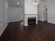 Living room with dark wood flooring, neutral walls, and a fireplace at 1909 Wexford Ct, Gastonia, NC 28054