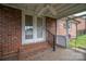 Covered brick porch with a ceiling fan, offering a cozy outdoor space at 1909 Wexford Ct, Gastonia, NC 28054