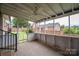 Enclosed porch featuring tiled floor, views of the backyard, and a fan overhead at 1909 Wexford Ct, Gastonia, NC 28054