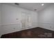 Room with dark floors and glass paneled doors at 1909 Wexford Ct, Gastonia, NC 28054