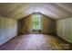 Attic room featuring hardwood floors and a window with natural light at 204 Blanche Ave, Belmont, NC 28012