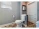 Traditional bathroom with white toilet, window, and vanity with a mirrored cabinet at 204 Blanche Ave, Belmont, NC 28012