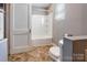 Cozy bathroom featuring a tub/shower combination and neutral colored flooring at 204 Blanche Ave, Belmont, NC 28012