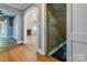 Hallway featuring hardwood floors and an archway that leads to the living room and stairs at 204 Blanche Ave, Belmont, NC 28012