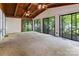 Spacious living area with wood beam ceilings, sliding glass doors, and open access to the kitchen at 204 Blanche Ave, Belmont, NC 28012