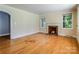 Cozy living room with hardwood floors, a fireplace, and bright windows offering natural light at 204 Blanche Ave, Belmont, NC 28012