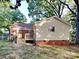 Exterior of home with deck and grassy backyard framed by mature trees at 2214 Grimes St, Charlotte, NC 28206