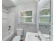 A white bathroom with standard tile shower at 2214 Grimes St, Charlotte, NC 28206
