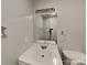 Bathroom featuring a white sink and vanity, a large mirror, and a simple light fixture, offering a clean aesthetic at 2214 Grimes St, Charlotte, NC 28206