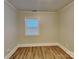 This bedroom features neutral walls, wood-look floors, and a window with blinds at 2214 Grimes St, Charlotte, NC 28206