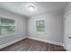 A simple gray bedroom with modern flooring and natural light from two windows at 2214 Grimes St, Charlotte, NC 28206