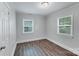 A simple gray bedroom with modern flooring and natural light from two windows at 2214 Grimes St, Charlotte, NC 28206