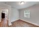 A light gray bedroom featuring hardwood floors and access to kitchen at 2214 Grimes St, Charlotte, NC 28206