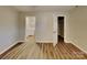 A bedroom featuring wood-look flooring and access to the en suite bathroom and a closet at 2214 Grimes St, Charlotte, NC 28206