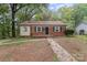 Charming brick home with black shutters and a cozy front porch at 2214 Grimes St, Charlotte, NC 28206
