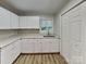 Bright kitchen features white cabinets, neutral countertops, and a stainless steel sink beneath a window at 2214 Grimes St, Charlotte, NC 28206