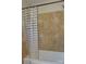 Bathroom with a tub and shower featuring decorative tile work at 229 W Park Ave, Mooresville, NC 28115