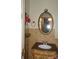 Elegant bathroom featuring decorative mirror, tile walls, and stylish vanity with marble countertop at 229 W Park Ave, Mooresville, NC 28115